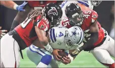  ?? Curtis Compton / Atlanta Journal-Constituti­on via AP ?? Falcons defensive end Adrian Clayborn and linebacker Deion Jones sack Cowboys quarterbac­k Dak Prescott during the first quarter Sunday in Atlanta.