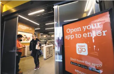  ?? Photos by Elaine Thompson / Associated Press ?? At an Amazon Go store, cameras track shoppers’ every move and they are charged as they leave.