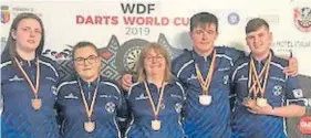  ??  ?? Scotland’s youth darts team did well in the World Cup in Cluj, Romania. They won overall bronze. Kyle Walker (Brechin) and Nathan Girvan (Forfar) won bronze in the boys pairs, Nathan and Chloe O’Brien (Blairgowri­e)won bronze in the mixed youth pairs and Chloe and Sophie McKinlay won silver in the girls pairs. From left — Chloe, Sophie, team manager Sharon McFarlane, Kyle and Nathan.