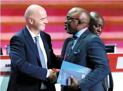  ??  ?? FIFA president, Gianni Infantino (L) shaking hands with newly elected member of FIFA Executive Council, Amaju Pinnick