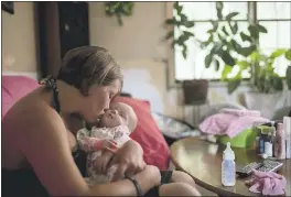  ?? WHITNEY CURTIS — THE WASHINGTON POST ?? Jennifer Kostoff kisses her 4-month-old daughter, Rikki, at her Granite City, Ill., home.