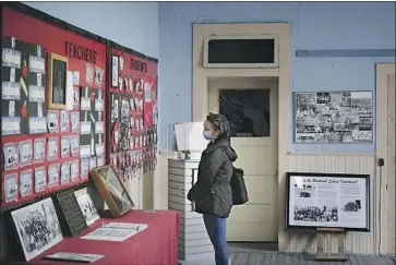  ?? Justin Hamel ?? OPENED in 1909 as a three-room “Mexican school,” Blackwell educated more than 4,000 Mexican American children before it closed in 1965. Above, Karen Brackett of Dallas visits the remaining school building this year.