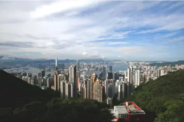  ?? — Reuters photo ?? A general view of Victoria Harbour and downtown skyline is seen from the Peak in Hong Kong, China. Asian family offices are evolving from being just investment focused to offering a platform for dispute resolution and succession planning, as the new generation in the family-owned businesses expand into newer areas, bankers said.