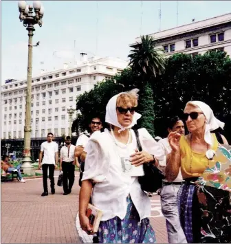  ?? Photo by Maggie Helwig ?? Mothers of the Plaza de Mayo in their characteri­stic headscarve­s, Buenos Aires, Argentina, December 1994.