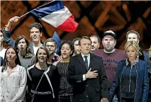  ?? PHOTO: REUTERS ?? French President elect Emmanuel Macron and his wife Brigitte Trogneux celebrate on the stage at his victory rally near the Louvre in Paris.