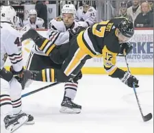  ??  ?? Bryan Rust gets upended by Chicago’s Jan Rutta.