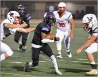  ?? ?? Oroville’s Peyton Frasure (4) tries to split two defenders during the Tigers’ matchup Friday against Las Plumas in Oroville. Las Plumas defeated Oroville for the second straight season in the annual rivalry game.