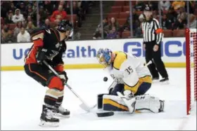  ?? JAE C. HONG — THE ASSOCIATED PRESS ?? Predators goaltender Pekka Rinne, right, stops a shot by Ducks’ Andrew Cogliano, Monday, in Anaheim