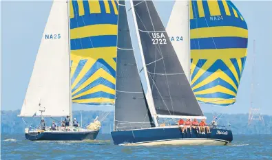  ?? WILLY KEYWORTH/SPINSHEET MAGAZINE ?? The J/120 Ma’m’selle sails upwind past a pair of Navy 44-footers sailing downwind.
