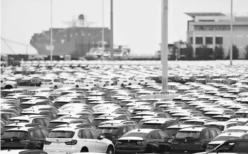  ??  ?? The Singapore-flagged vehicle carrier Lord Vishnu unloads Kia vehicles at the Georgia Ports Authority Brunswick Docks on Aug 16, 2013, in Brunswick, Georgia.