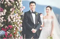  ?? Yonhap ?? Hyun Bin, left, and Son Ye-jin pose during their wedding ceremony in Seoul, March 31.