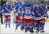  ?? JOHN MINCHILLO — THE ASSOCIATED PRESS ?? Rangers defenseman Ryan Lindgren (55) and center Mika Zibanejad (93) celebrate after Game 2of the Eastern Conference finals against the Tampa Bay Lightning. The Rangers take a 2-0 series lead to Florida.