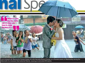  ??  ?? Love conquers all: Ramoncito Campo kisses his wife Hernelie Ruazol Campo on a flooded street on Wednesday during the aftermath of a monsoon that battered Manila, causing an estimated 66 deaths