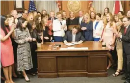  ?? COURTESY ?? Gov. Ron DeSantis signed a six-week abortion ban in private in his office on April 13, 2023.