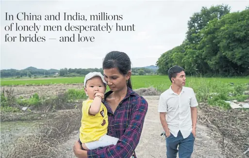  ?? YAN CONG FOR THE WASHINGTON POST ?? Sreynich Yorn, holding her 9-month-old daughter, walks in the village with her husband Liu Hua in Leping, China.