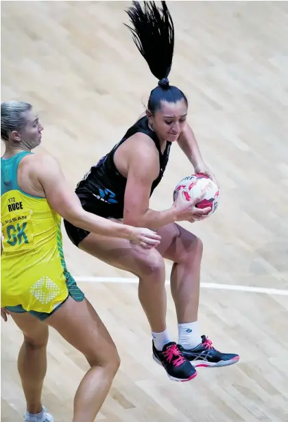  ?? Photo / Photosport ?? Tiana Metuarau makes an aerial catch as the Silver Ferns try to gain a foothold against Australia.
