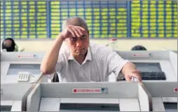  ?? XU CONGJUN / FOR CHINA DAILY ?? An investor monitors stock price changes at a securities brokerage in Nantong, Jiangsu province, on