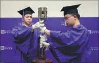  ?? PHOTOS PROVIDED TO CHINA DAILY ?? Top: Graduates and professors of Duke Kunshan University take a group photo during an online graduation ceremony. Above: New York University Shanghai hosts its 2020 commenceme­nt on May 29.