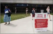  ?? PHIL LONG — THE ASSOCIATED PRESS FILE ?? Students exit the Ice Arena at Kent State University in Kent, Ohio, after getting a Johnson & Johnson COVID-19 vaccinatio­n.