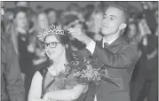  ??  ?? Riley McCoy has her crown placed by last year’s homecoming king, Jimmy Quick, during halftime of the Dana Hills High School football game on Friday.