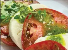  ?? (Arkansas Democrat-Gazette/Kelly Brant) ?? Basil Vinaigrett­e stands in for the fresh basil leaves in this Easy Caprese salad.