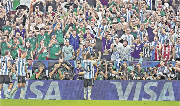  ?? AP ?? Lionel Messi celebrates before the Argentina fans after scoring a brilliant opening goal in the win over Mexico in Group C at the Lusail Stadium in Doha on Saturday.