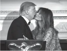  ?? AGENCE FRANCE PRESSE ?? US President Donald Trump kisses First Lady Melania Trump as they host the White House Historical Associatio­n dinner at the White House in Washington, DC.