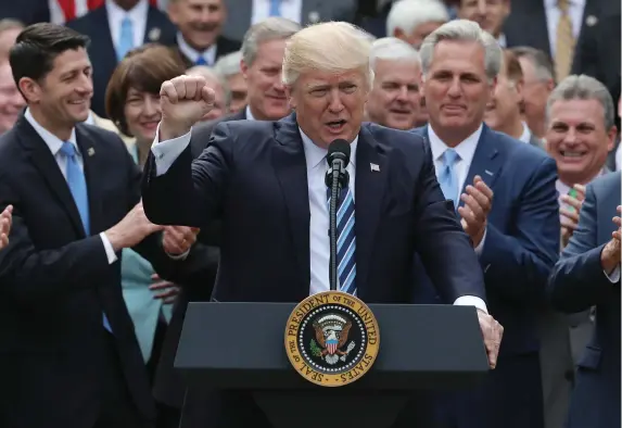  ??  ?? US President Donald Trump celebrates with Congressio­nal Republican­s in the Rose Garden of the White House after the House of Representa­tives approved the American Healthcare Act