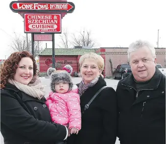  ?? JASON KRYK ?? Breanne Renaud, left, her one year-old daughter Autumn, and her parents Gail and Dave Hayes stand outside the Lone Fone Restaurant on Walker Road on Friday. With the owners retiring, many regular customers have said it’s sad to see the popular Chinese eatery close after 46 years.