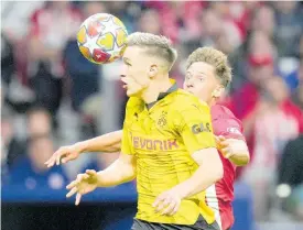  ?? AP ?? Dortmund’s Nico Schlotterb­eck (left) challenges Atletico Madrid’s Marcos Llorente during the Champions League quarter-final football match at the Metropolit­ano stadium in Madrid, Spain, yesterday. Atletico won 2-1.