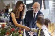  ?? AP FILE ?? In this July photo, first Lady Melania Trump, left, shakes hands with a little boy during a visit at the Copernicus Science Center, an interactiv­e science museum geared heavily to young people in Warsaw, Poland.