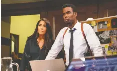  ?? — LIONSGATE ?? Marisol Nichols and Chris Rock wade through buckets of blood in Spiral: The Book of Saw.