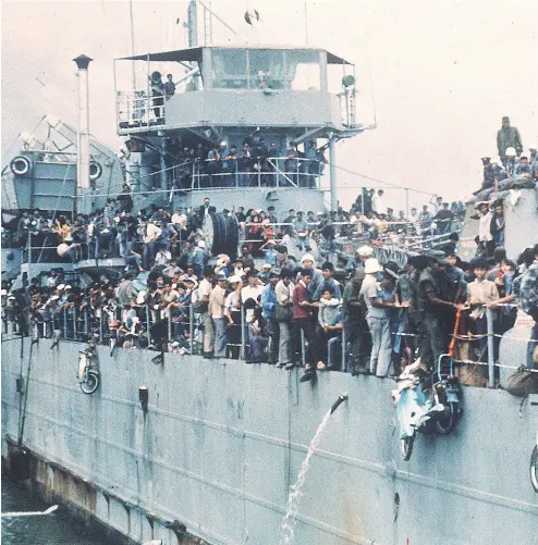  ?? STAFF / AFP / GETTY IMAGES FILES ?? Jam-packed with more than 7,000 refugees, a South Vietnamese navy ship arrives at South Vietnam’s most popular sea resort in the early 1970s. “Thanks to my father and mother,” Viet Thanh Nguyen writes. “Refugees in 1954 and again in 1975, they are the...