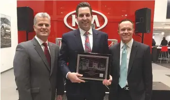  ??  ?? (Pictured l to r) Scott Fitzgerald, director Kia Central Region; Francis Mauro, co-owner Internatio­nal Kia; and William Peffer, vice president U.S. Kia sales, pose with the plaque recognizin­g the opening of the Orland Kia facility.