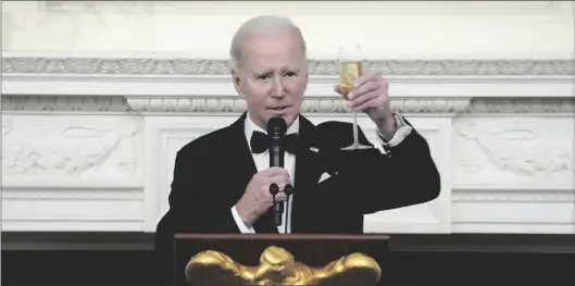  ?? AP PHOTO/MANUEL BALCE CENETA ?? President Joe Biden toasts during a dinner reception for governors and their spouses in the State Dining Room of the White House, on Saturday in Washington.