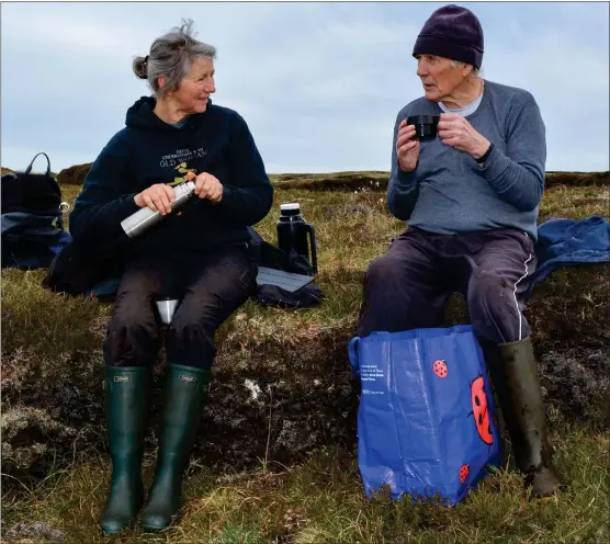  ?? Picture: Alison Pinkney ?? Margaret Rowan and Donald John Morrison take a break from cutting peat on Lewis. Donald John has lived on the island all his life but Margaret is a newcomer