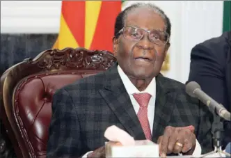  ?? The Associated Press ?? Zimbabwean President Robert Mugabe delivers his speech during a live broadcast at State House in Harare, on Sunday. Zimbabwe's President Robert Mugabe has baffled the country by ending his address on national television without announcing his...