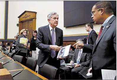  ?? AP/JACQUELYN MARTIN ?? Federal Reserve Board Chairman Jerome Powell (left) speaks Wednesday with Rep. Keith Ellison, D-Mich., during a break in Powell’s testimony before the House Committee on Financial Services in Washington.