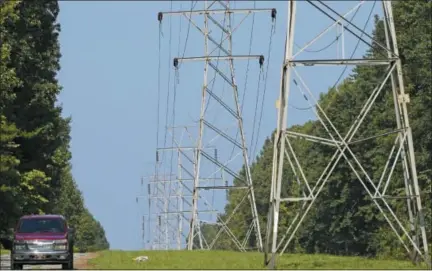  ?? THE ASSOCIATED PRESS ?? Power transmissi­on lines deliver electricit­y to rural Orange County near Hillsborou­gh, N.C. Electric utilities are pouring billions of dollars into a race to prevent terrorists or enemy government­s from shutting down the power grid while also making the delivery system ready for a world with much more renewable energy.