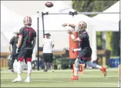  ?? RANDY VAZQUEZ — BAY AREA NEWS GROUP ?? The San Francisco 49ers’ Jimmy Garoppolo, right, throws a pass during practice at Levi’s Stadium in Santa Clara on Sunday. Garoppolo is working on his deep passes.