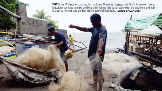  ?? (LYNDE SALGADOS) ?? WITH the Philippine­s bracing for typhoon Ompong, Cagayan de Oro’s fishermen along Macajalar bay have to make do fixing their fishing nets to be ready when the weather condition is back to normal, and so their daily source of livelihood.