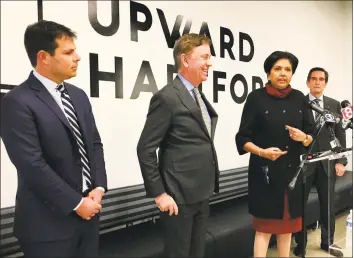  ?? Dan Haar/Hearst Connecticu­t Media ?? Gov. Ned Lamont has brought in The Boston Consulting Group to help with reopening the state. Lamont, center, is shown with his economic team in 2019. From left, David Lehman, Commission­er of the state Department of Economic and Community Developmen­t; Lamont; Indra Nooyi, retired chairman and CEO of PepsiCo; and Jim Smith, former CEO of Webster Bank. Nooyi and Smith are co-chairs of AdvancCT, a quasi-public developmen­t agency; and Nooyi is also co-chair of the reopening advisory committee.