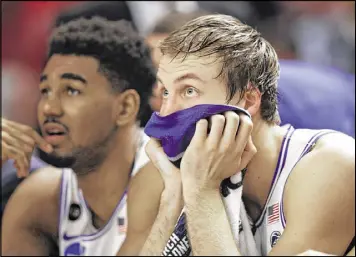  ?? CHUCK BURTON / ASSOCIATED PRESS ?? Duke’s Luke Kennard (right) watches the final minutes in the Blue Devils’ 88-81 loss Sunday to South Carolina. The Gamecocks are in the Sweet 16 for the first time after hanging 65 second-half points on the preseason No. 1-ranked Duke.