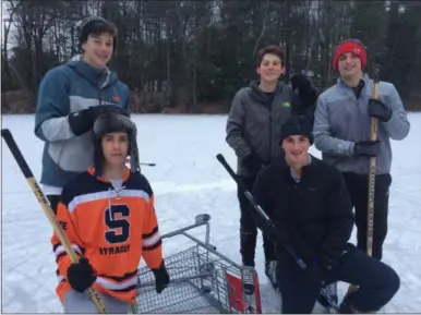  ?? PAUL POST — THE SARATOGIAN ?? Saratoga Central Catholic High School students comprise a formidable pond hockey team. Front, left to right, are Jack Munn and Garrett Quinn; back, left to right, are Caden Awadie, Jake Welcome and Nick Condry.