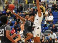  ?? AUSTIN HERTZOG - DIGITAL FIRST MEDIA FILE ?? The Hill School’s Chase Audige (15) drives to the rim as Westtown’s Jakob Forrester defends during the PAISAA semifinals at Neumann University.