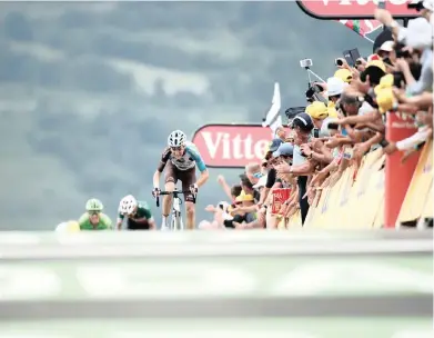  ??  ?? OVER THE HILL, AND NOT SO FAR AWAY: Romain Bardet of France sprints towards the line to win the 12th stage of the Tour de France yesterday. He timed his break to perfection to win by two seconds.