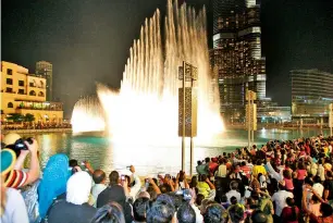  ?? Tourists watch the Dancing Fountain in Dubai. China and Russia have moved up in their rankings as key source markets for inbound tourism to Dubai, with China entering the top four. — Supplied photos ??