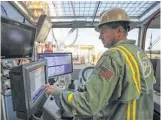  ?? Steve Gonzales / Houston Chronicle ?? Precision Drilling’s Steve Brouwer works in the control room of a new drilling rig assembled at its plant in Houston.