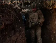  ?? NICOLE TUNG — THE NEW YORK TIMES ?? A Ukrainian soldier prepares a shell for firing March 27 in the Donetsk region of Ukraine. Without additional aid from the United States, Ukraine will run out of vital 155-millimeter shells.