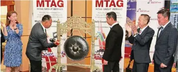  ??  ?? Going public: Chaw hitting the gong to mark the company’s listing on the Ace Market.
